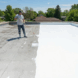 Liquid rubber roof coating applied on flat residential roof