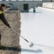 Close-up of a hand applying an EPDM roof repair tape.