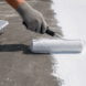Liquid rubber roof coating being applied to create a durable waterproof roof surface