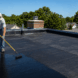 Homeowner fixing a leaking backyard pond using pond sealant for a simple DIY pond leak repair.