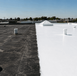 Professional roofer applying reflective EPDM roof coating for UV protection and energy savings